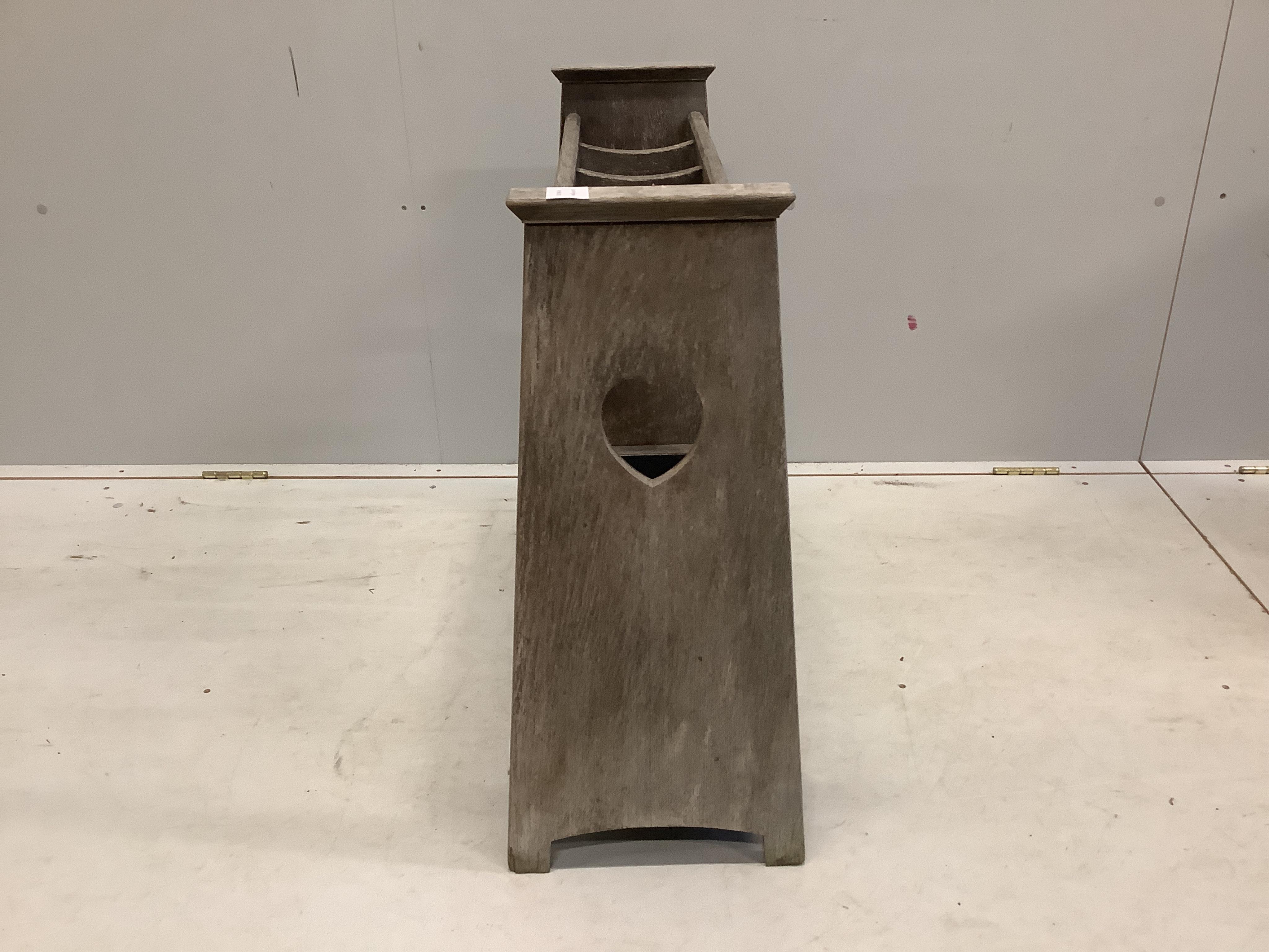 An Arts and Crafts style bleached oak five division stick stand, width 78cm, depth 30cm, height 69cm. Condition - poor to fair